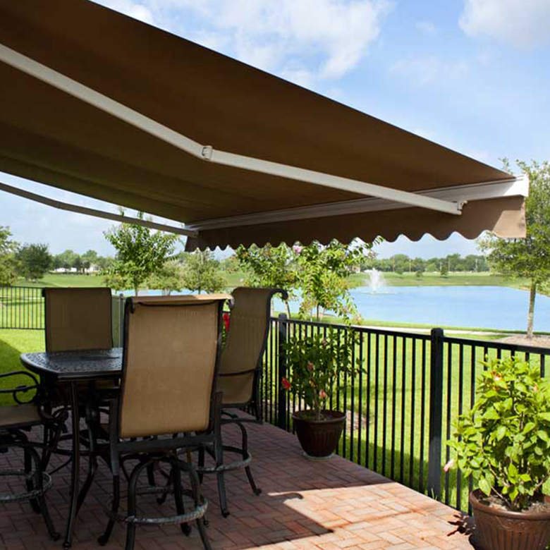 Rollac's Retractable Awning Over A Backyard Patio Seating Area