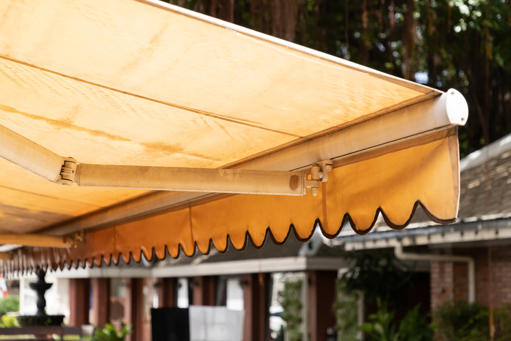Dusty yellow awnings that need to be cleaned