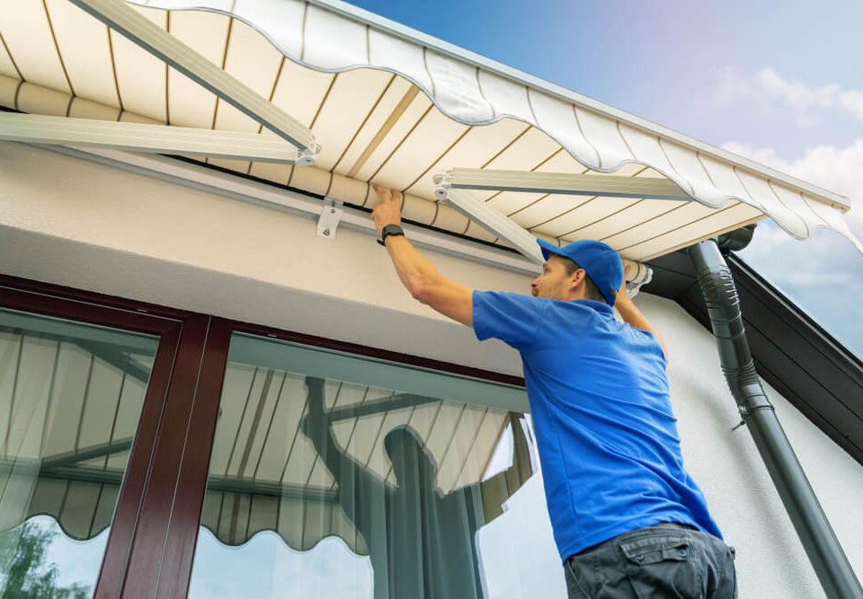 Person giving maintenance to an awning