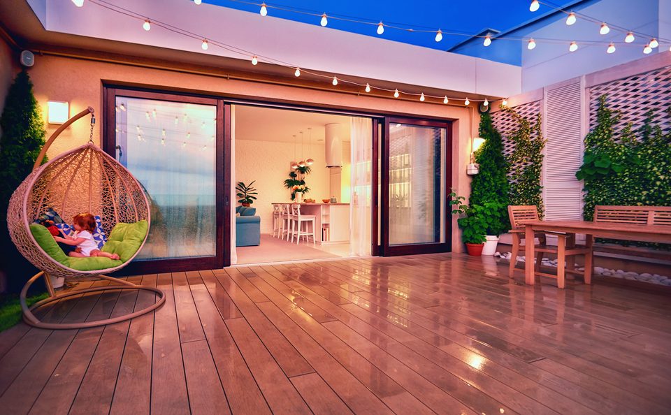 Beautiful rooftop deck with furniture and string lights