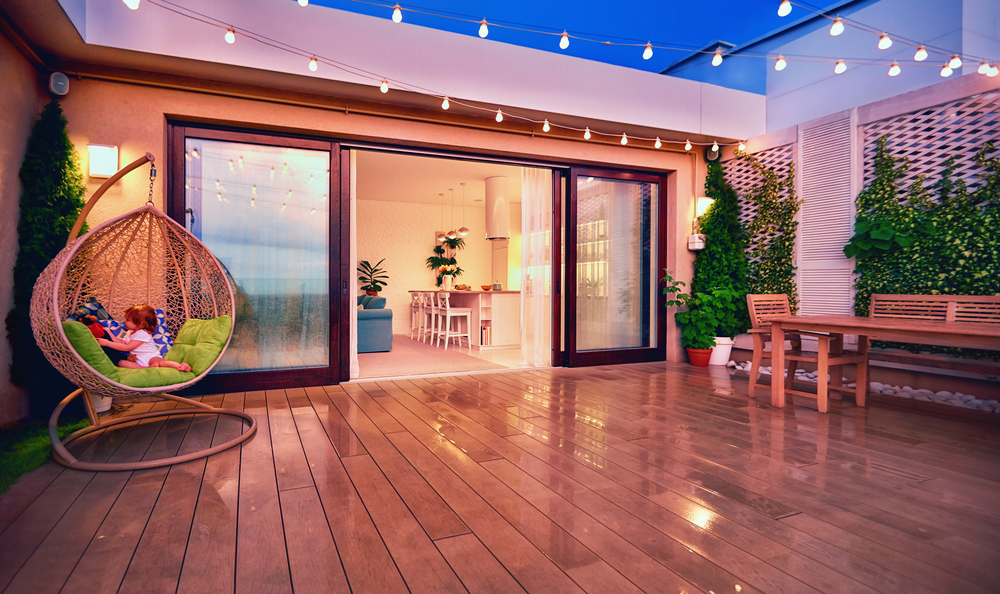 Beautiful rooftop deck with furniture and string lights