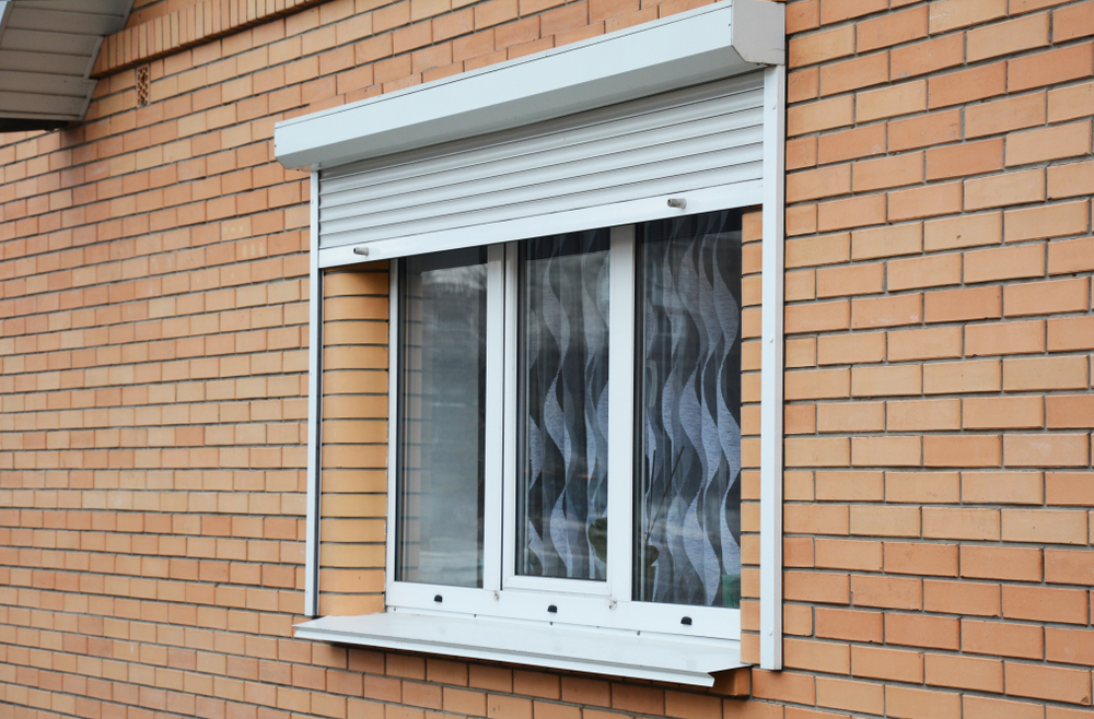 Window with rolling shutters installs to prevent cold air from entering the house