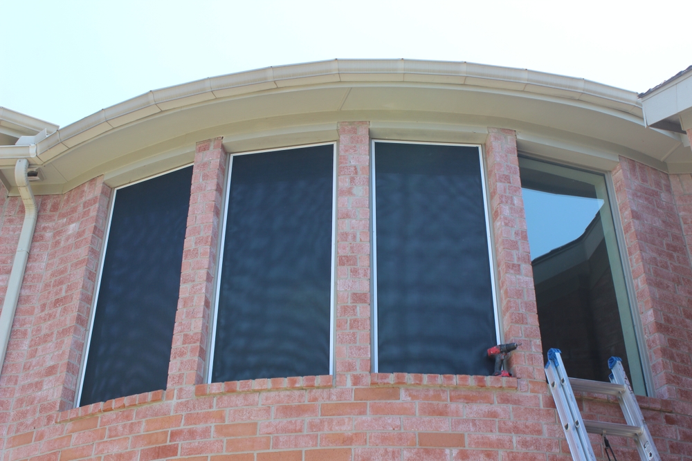 Solar screens installed on the windows of a house