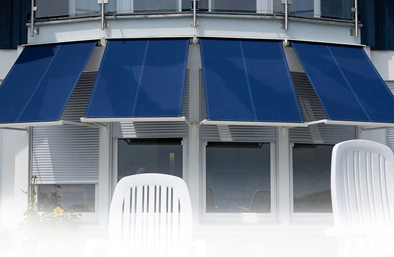 Striking Blue Rollac Awnings Adding Style and Shade to White Windows