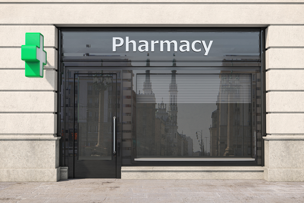 Storefront view of pharmacy with security shutters installed
