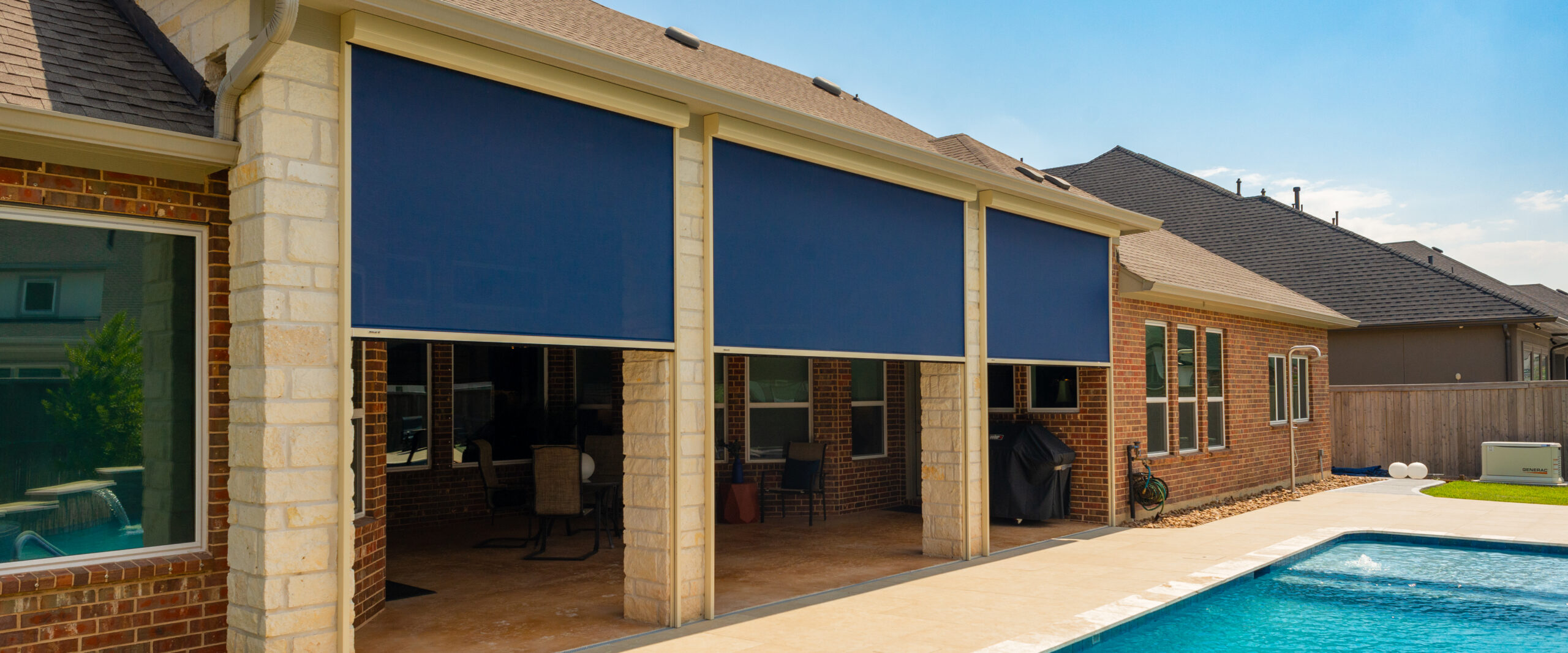 External View of Blue Patio Shades Installed at a House with Pool
