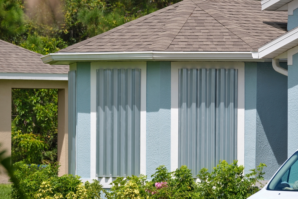 Steel Hurricane Shutters Installed at House Windows as An Affordable Solution