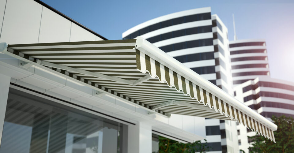 White and Green Awning Installed over Store Window