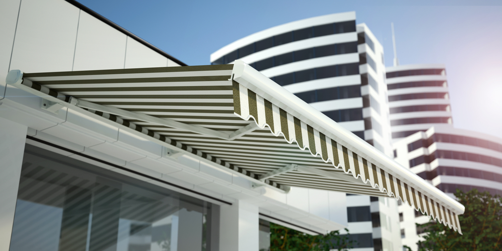 White and Green Awning Installed over Store Window