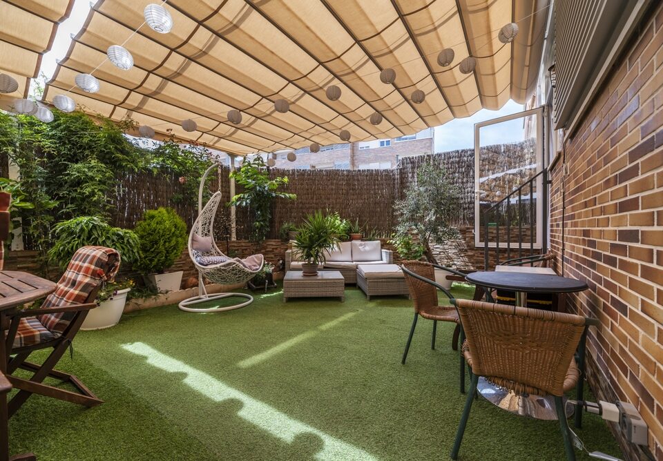 Patio with Grass Floor, Outdoor Furniture, Plants, and Extended Retractable Awning