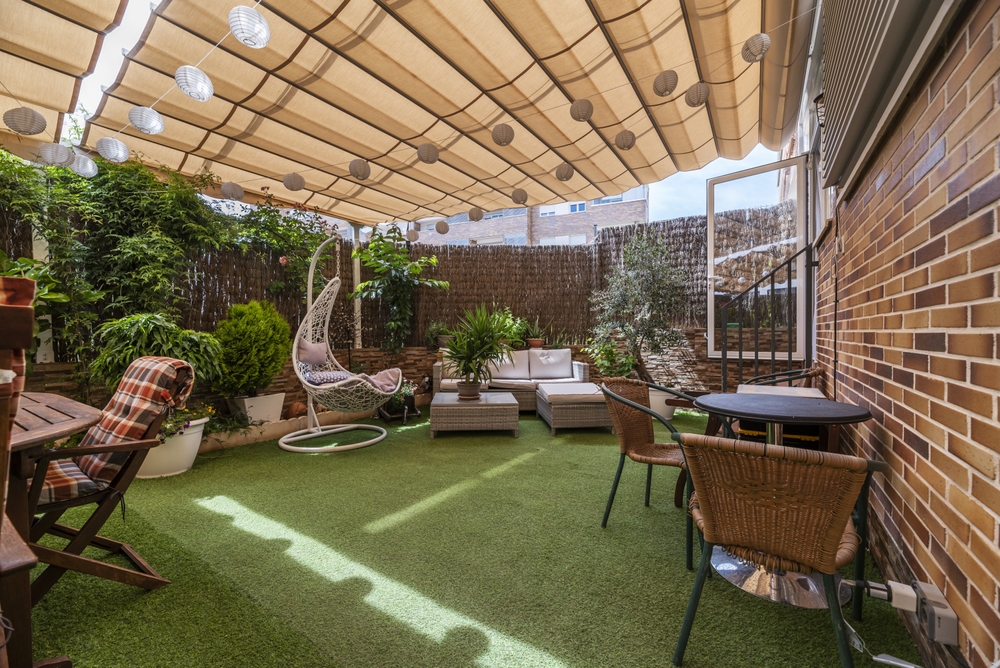 Patio with Grass Floor, Outdoor Furniture, Plants, and Extended Retractable Awning