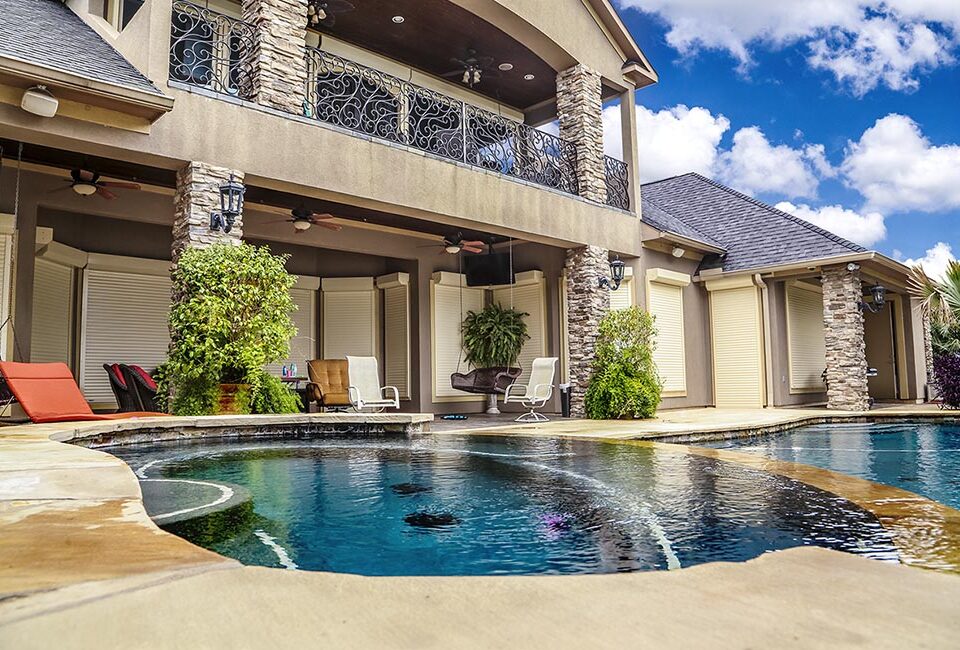 Two Story White Stone Home with Retractable Automated Window