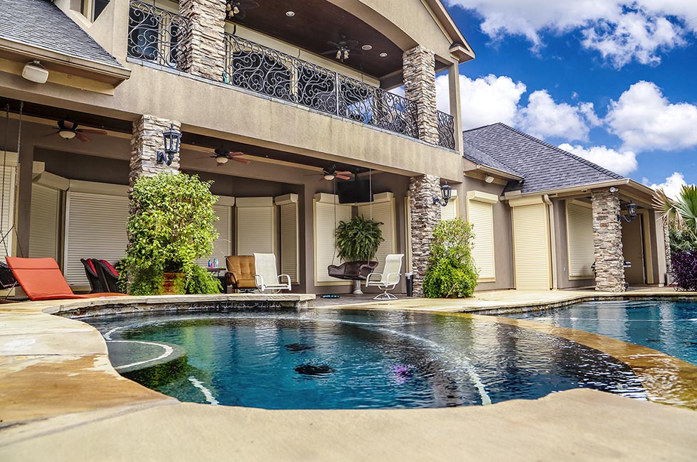 Two Story White Stone Home with Retractable Automated Window